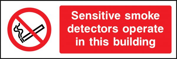 Sensitive smoke detectors operate in this building sign