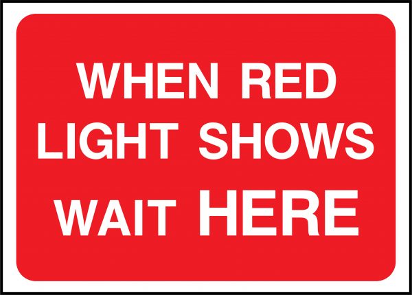 When red light shows wait here road sign
